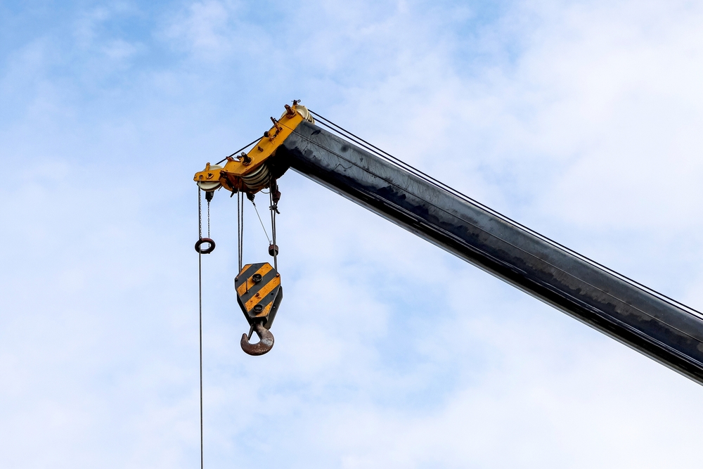 Closeup,of,an,old,lifting,hook,attached,to,sheave,suspended